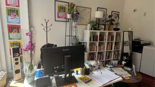 Response Community projects office and desk with lots of Loved and Wanted posters on the wall
