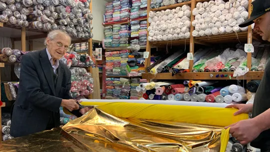 Tailor cutting fabric