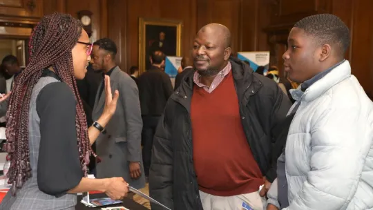 Two men asking for information at event