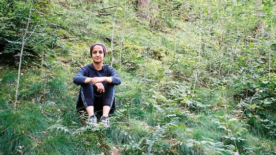 Volunteer sitting around greenery