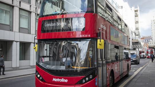 A photo of an electric red TfL bus in London.