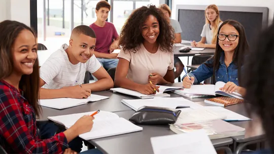 Students around a table in a classroom