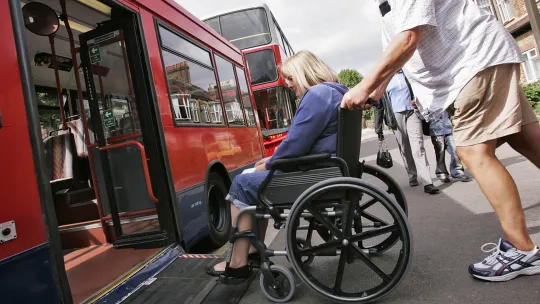 A wheelchair user accessing a bus