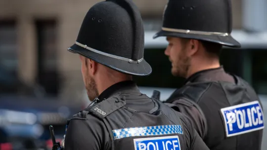 Two police officers walk side by side