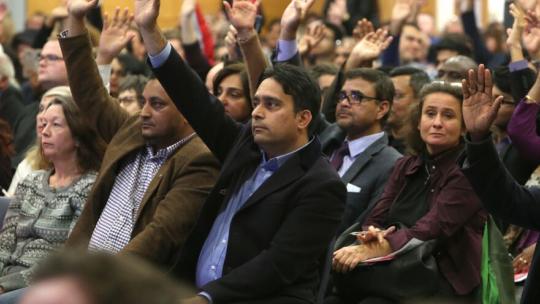 A member of public raising their hand during People's Question Time.