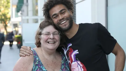 Young man hugging woman
