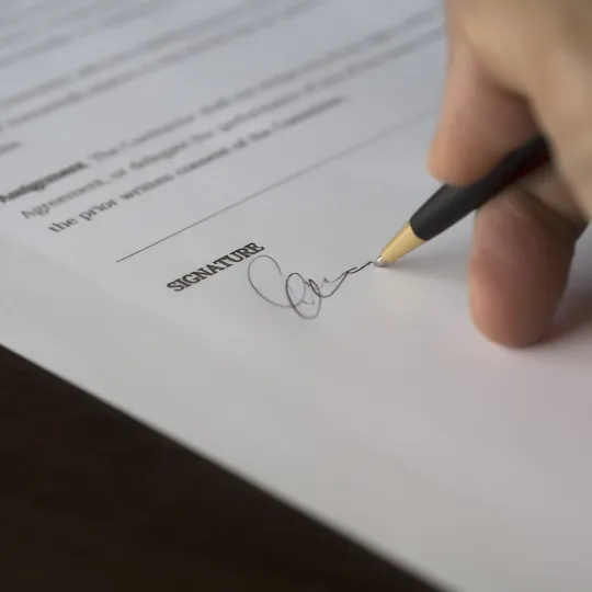 Hand of person signing document