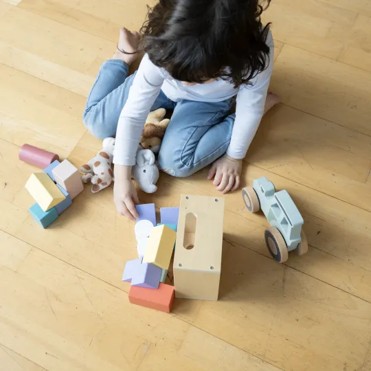 Child playing with wooden toys