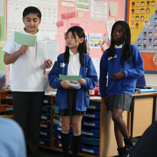 young people reading off papers