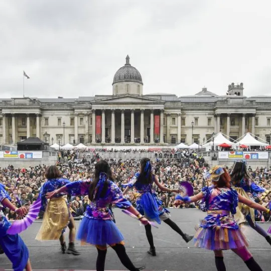 Image taken from stage at Trafalgar Square of backs of dancers and crowd watching. 