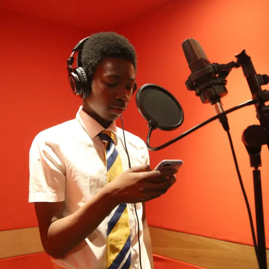 person using microphone in recording studio