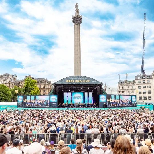 Cast of Mamma Mia on stage and view of the crowd at West End LIVE on Trafalgar Square, 2025
