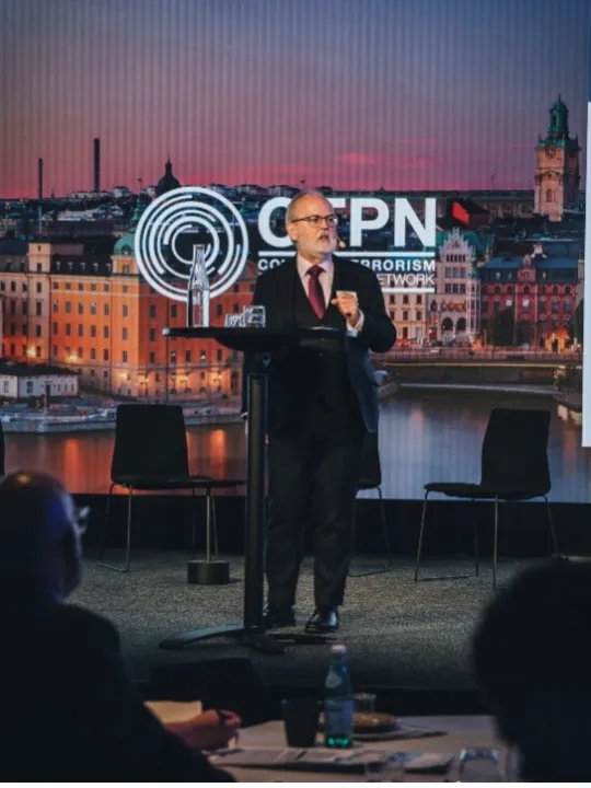Dr Paul Martin CBE on CTPN conference stage.