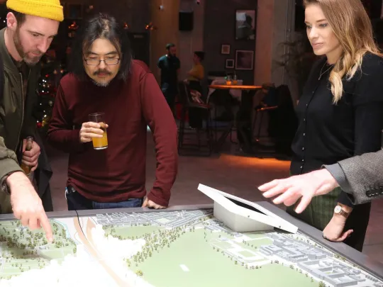 People looking at scale model at OPDC Winter Warmer event