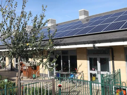 A school roof building covered in solar panels