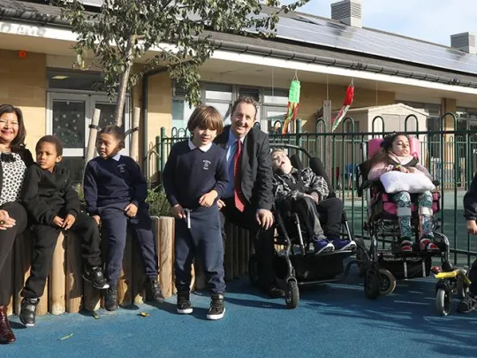 Ealing school program strategies kids and two adults in school playground