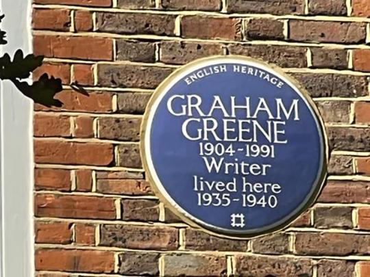 Graham Greene Plaque outside the building in blue circle shape