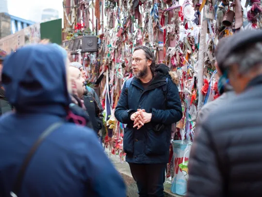 UnseenTours with group of people listening to a tour guide