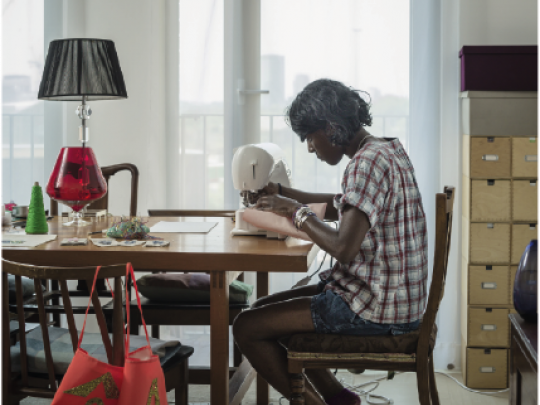 A woman sewing at her dining table