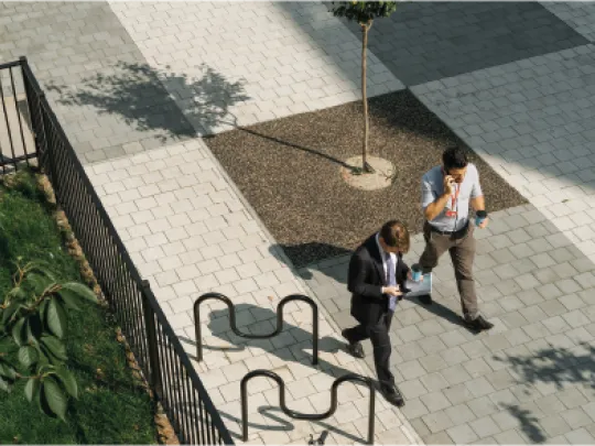 Overhead view of people walking across interesting paving
