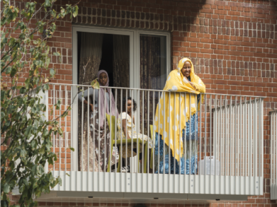 A family enjoys the balcony of their flat