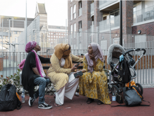 Women talking on a bench in a new development