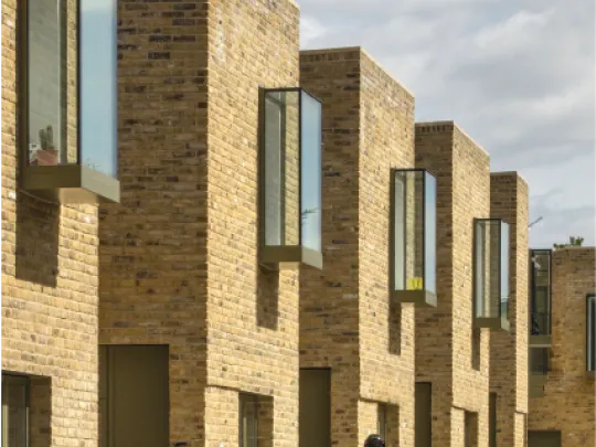 A jogger walks past new houses