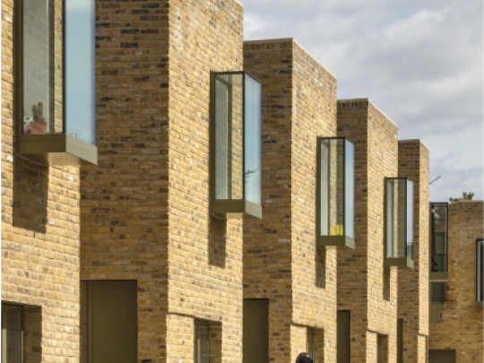 A jogger walks past new houses