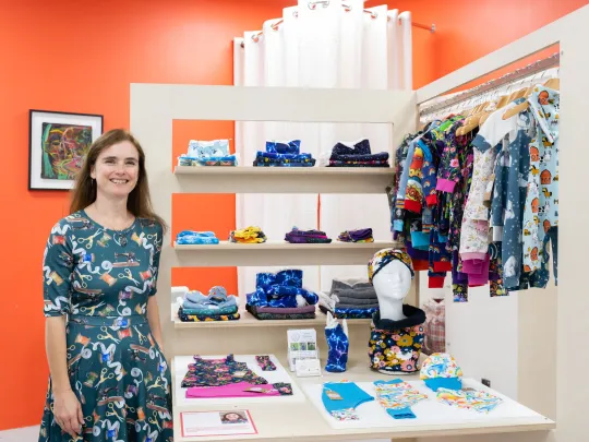 Woman with display of children's clothes