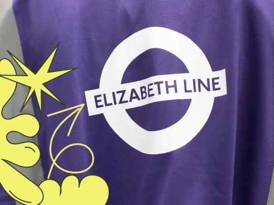 Elizabeth line icon on fabric, with a yellow graphic overlay pointing to it