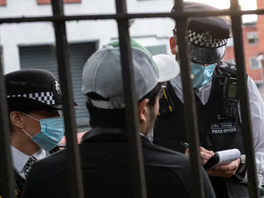 Two police officers questioning a person