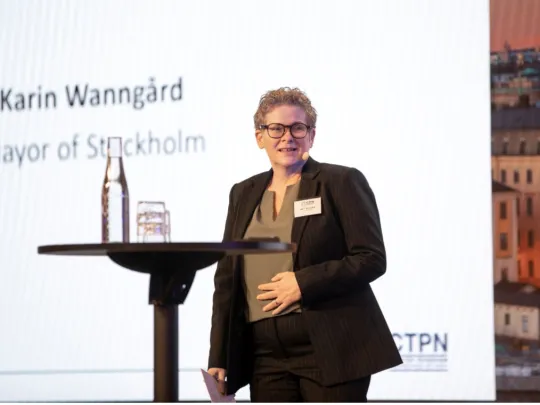 Karin Wanngård, Mayor of Stockholm, on a conference stage.
