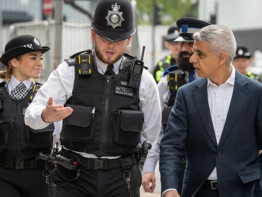 Mayor of London, Sadiq Khan, talking to a police officer on a visit