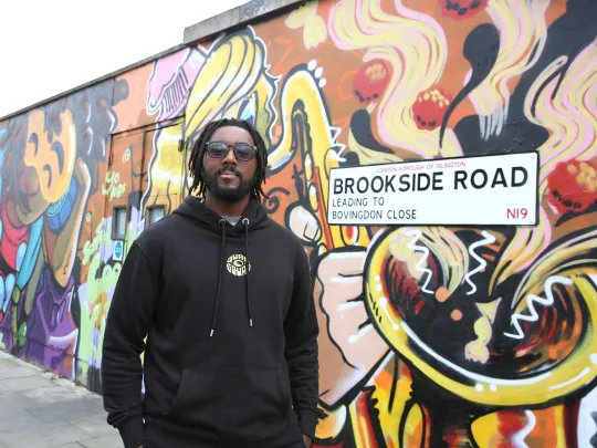 person standing in front of wall with mural