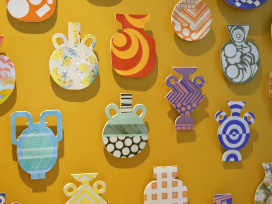 colourful ceramics on a yellow wall