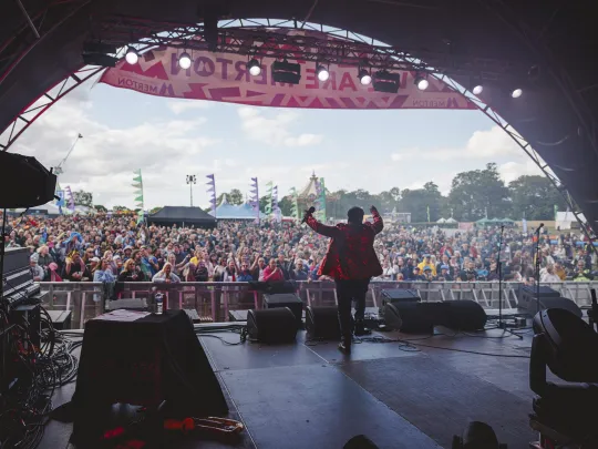 Performer on stage at the Merton Festival