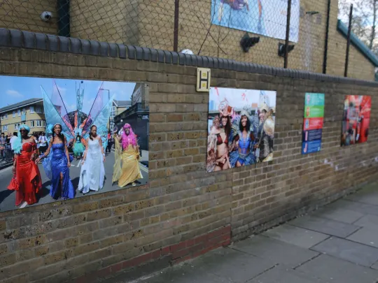 artwork and photos on brick wall 