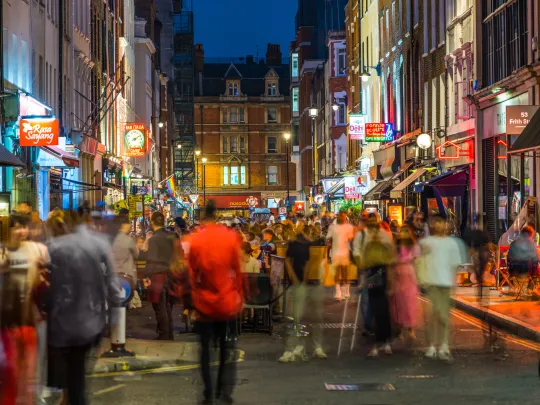 Crowds on busy London street at night