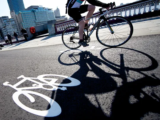 Cyclist riding over a bridge