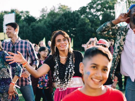 Adults and children dancing