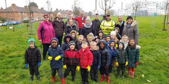 St Helier group picture of children and adults standing together in a park