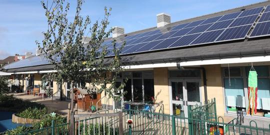 Ealing School program strategies with school roof building covered in solar panels