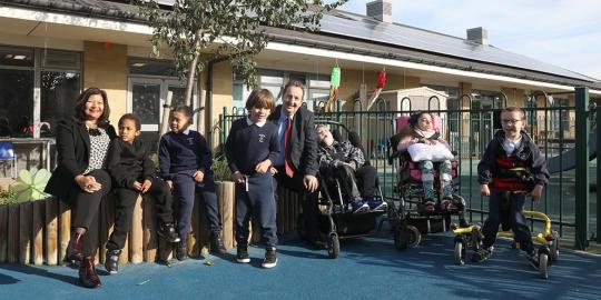 Ealing school program strategies kids and two adults in school playground