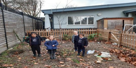 Greening Tottenham school environment with 4 children standing
