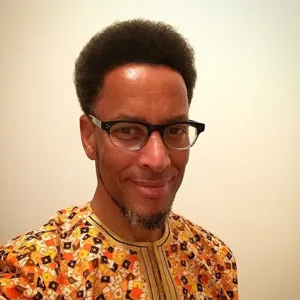 Mugshot of Kenneth face wearing glasses