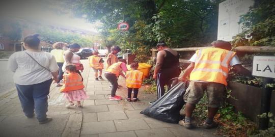 Nature vibezzz environment environment with adult and children cleaning the street 