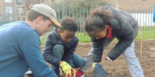 Patmore forest garden environment with kids digging with an adult male