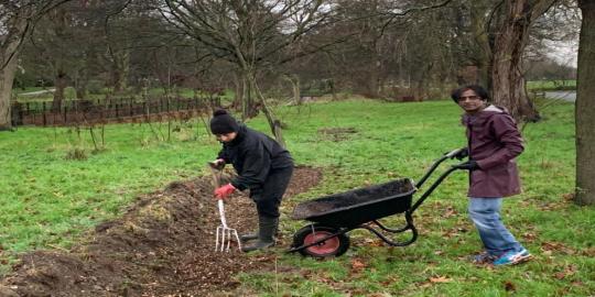 Valentines park infrastructure environment two people with a spade and wheelbarrow digging