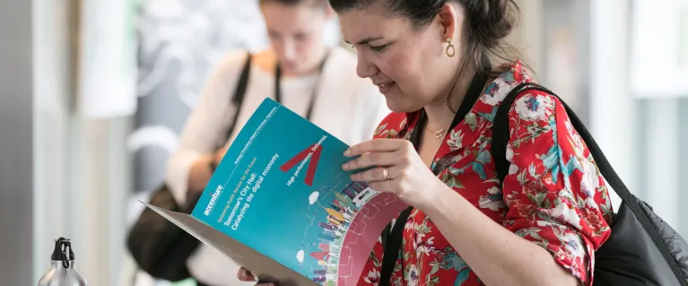 Woman reading information on a Smart London guide