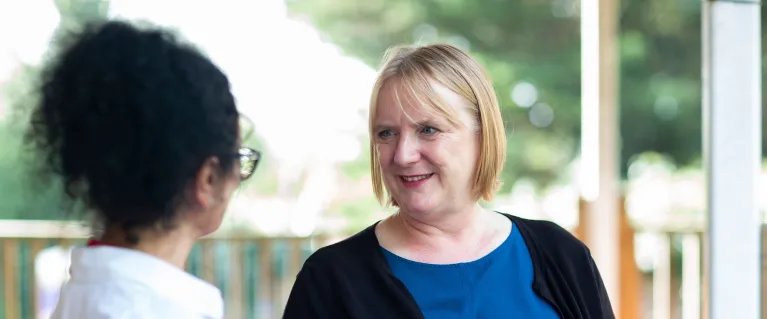 Two women talking to each other at Alton Community Playschool